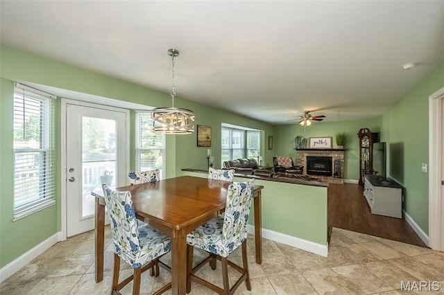 5 Poor Richard Ct, Ofallon, MO 63366 - dining room featuring a fireplace, a chandelier, and a ceiling fan