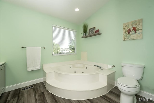 5 Poor Richard Ct, Ofallon, MO 63366 - bathroom featuring a jetted tub, wood finished floors, vaulted ceiling, and vanity
