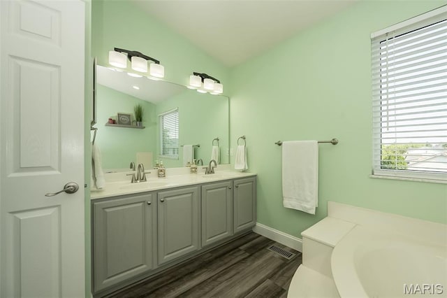 5 Poor Richard Ct, Ofallon, MO 63366 - full bathroom featuring double vanity, wood finished floors, and a garden tub