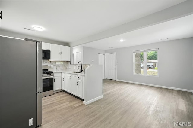 260 S Hartnett Ave, Saint Louis, MO 63135 - kitchen featuring appliances with stainless steel finishes, light wood-style floors, light countertops, and tasteful backsplash