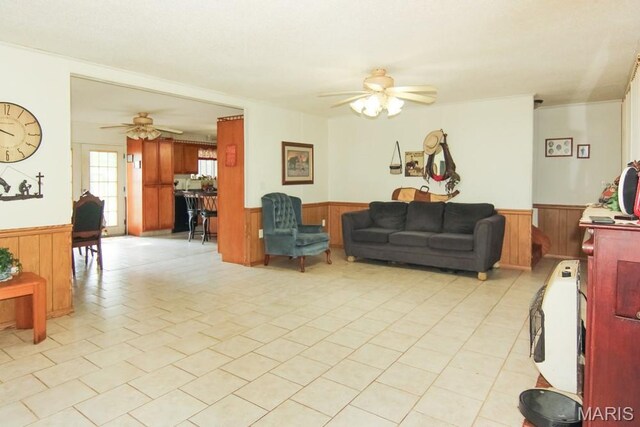 17748 State Highway C, Advance, MO 63730 - living area featuring wainscoting, a ceiling fan, wood walls, and light tile patterned floors