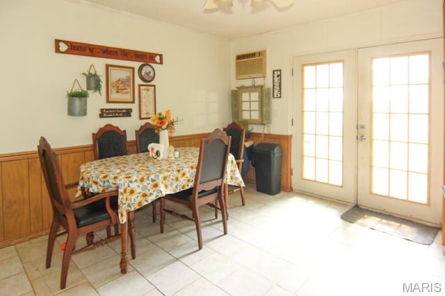 17748 State Highway C, Advance, MO 63730 - dining area featuring a wainscoted wall, healthy amount of natural light, french doors, a ceiling fan, and wooden walls