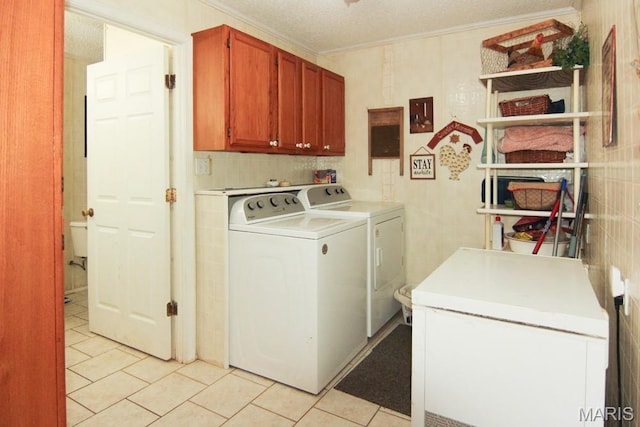 17748 State Highway C, Advance, MO 63730 - laundry area featuring washing machine and dryer, cabinet space, light tile patterned flooring, and ornamental molding
