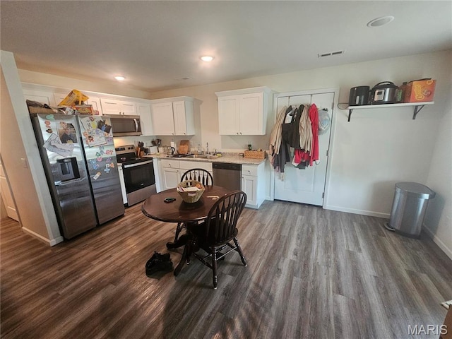 292 Southview Dr, Jackson, MO 63755 - kitchen with stainless steel appliances, dark wood-style floors, white cabinetry, light countertops, and baseboards