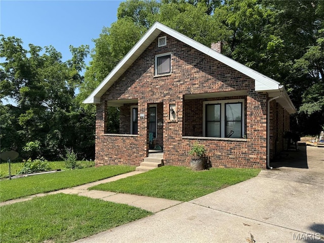 111 N Levering Ave, Hannibal, MO 63401 - bungalow with brick siding, a front yard, and covered porch