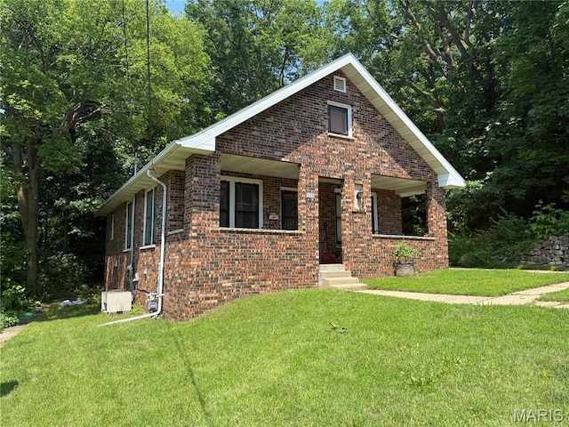 111 N Levering Ave, Hannibal, MO 63401 - view of front of property with brick siding, a front lawn, and covered porch