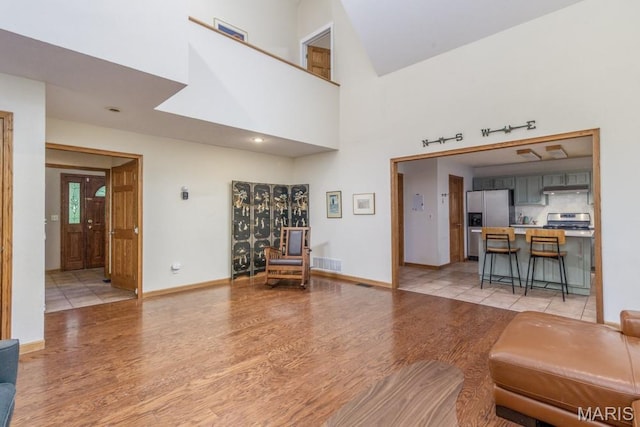25350 Englewood Ln, Lebanon, MO 65536 - living area with light wood-type flooring, a high ceiling, and baseboards