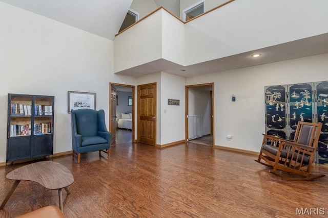 25350 Englewood Ln, Lebanon, MO 65536 - sitting room featuring wood finished floors, a high ceiling, radiator heating unit, baseboards, and recessed lighting
