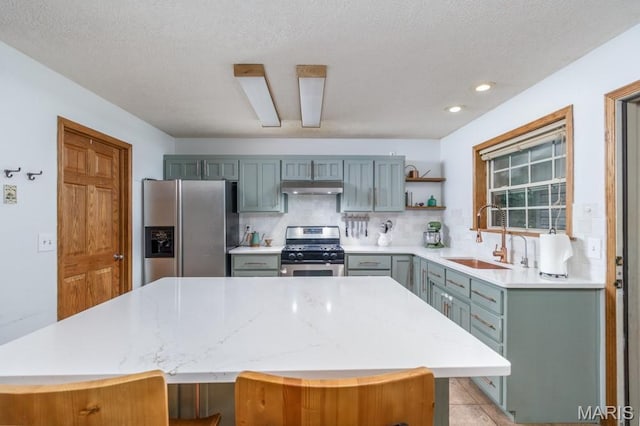 25350 Englewood Ln, Lebanon, MO 65536 - kitchen featuring stainless steel appliances, a sink, under cabinet range hood, open shelves, and backsplash