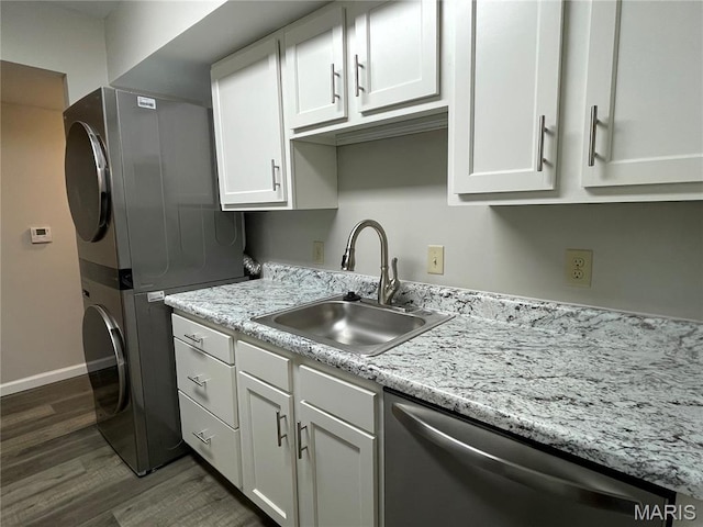 9158 Eager Rd, Brentwood, MO 63144 - kitchen featuring dishwasher, stacked washer / dryer, dark wood finished floors, white cabinets, and light stone countertops