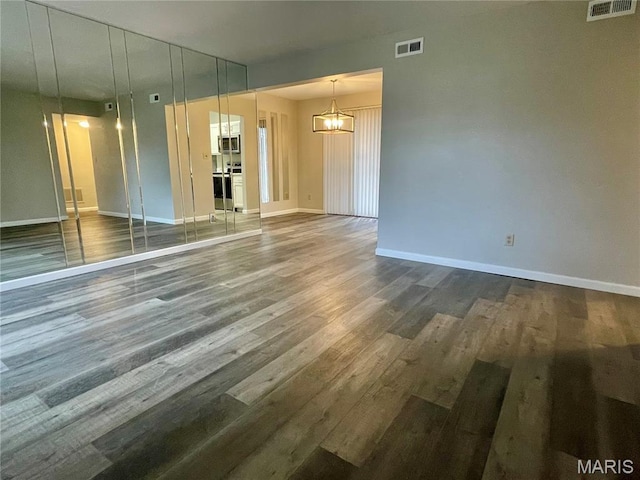 9158 Eager Rd, Brentwood, MO 63144 - unfurnished room with a chandelier and wood finished floors