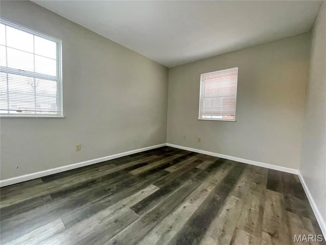 9158 Eager Rd, Brentwood, MO 63144 - empty room featuring baseboards and dark wood-style flooring