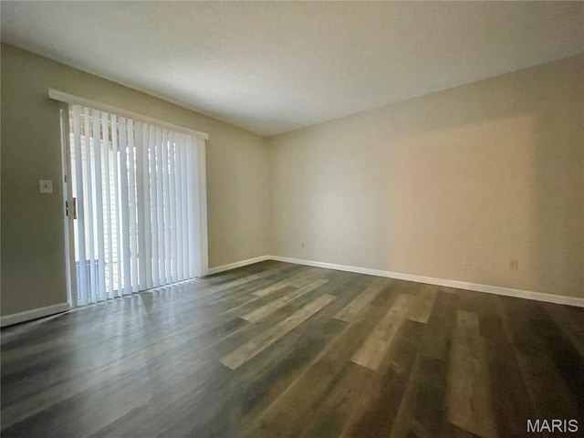 9158 Eager Rd, Brentwood, MO 63144 - unfurnished room with baseboards and dark wood-style flooring