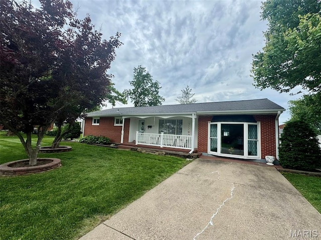 115 Park St, Monroe City, MO 63456 - ranch-style home featuring a porch, brick siding, and a front lawn