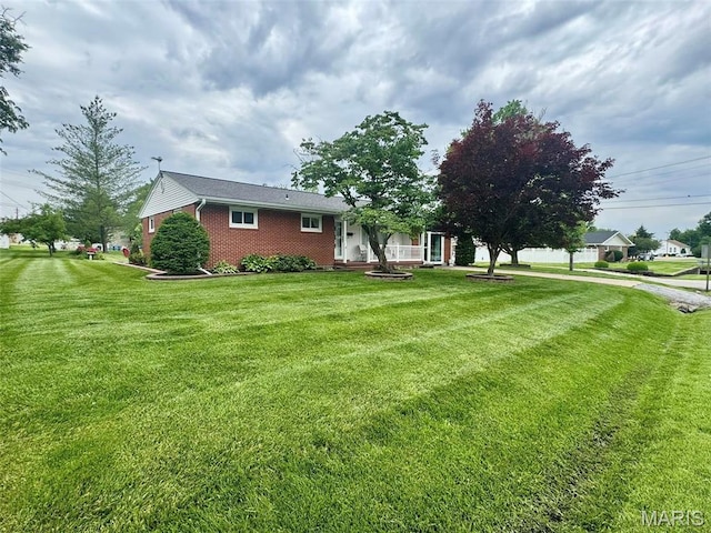 115 Park St, Monroe City, MO 63456 - view of front of home featuring a front lawn and brick siding