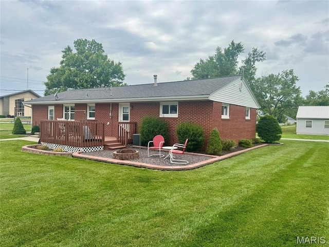 115 Park St, Monroe City, MO 63456 - back of house with an outdoor fire pit, a deck, brick siding, a yard, and central AC unit