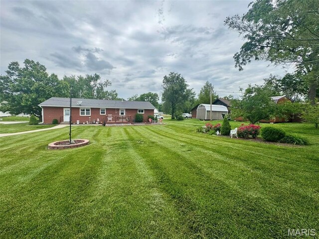 115 Park St, Monroe City, MO 63456 - view of green lawn featuring a wooden deck