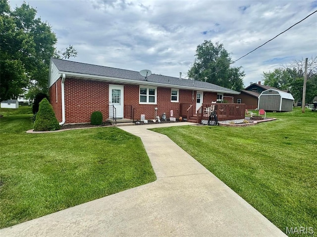 115 Park St, Monroe City, MO 63456 - back of property with brick siding, a wooden deck, and a lawn