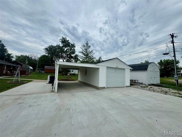 115 Park St, Monroe City, MO 63456 - garage with driveway and a storage unit