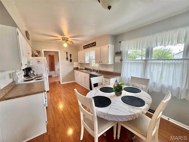 115 Park St, Monroe City, MO 63456 - dining space with light wood-style floors, baseboards, and a ceiling fan