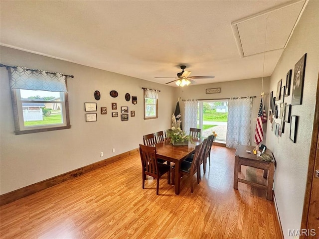 115 Park St, Monroe City, MO 63456 - dining room with attic access, light wood-style flooring, a ceiling fan, and baseboards