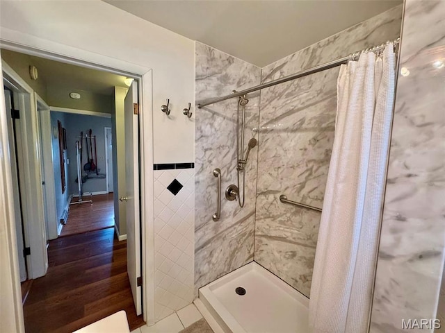 115 Park St, Monroe City, MO 63456 - bathroom featuring a stall shower, tile walls, and wood finished floors