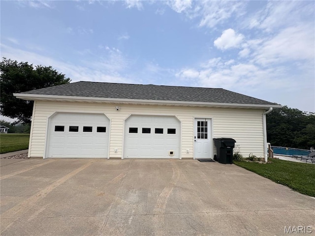 3581 Eagle Crest Dr, Palmyra, MO 63461 - view of side of property featuring a garage, driveway, an outbuilding, and a shingled roof