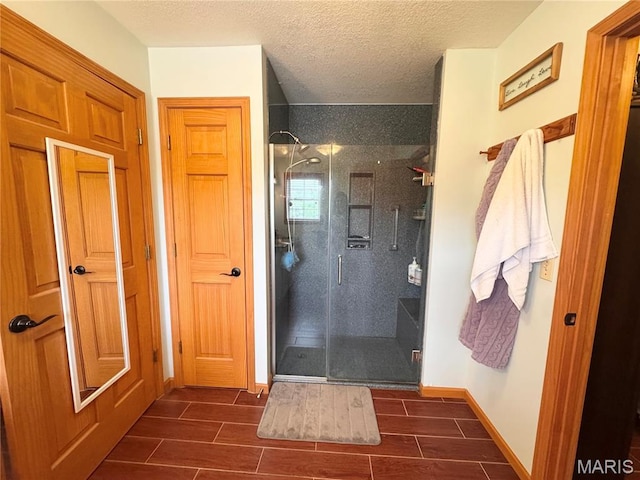 3581 Eagle Crest Dr, Palmyra, MO 63461 - full bath with a stall shower, wood tiled floors, a textured ceiling, and baseboards