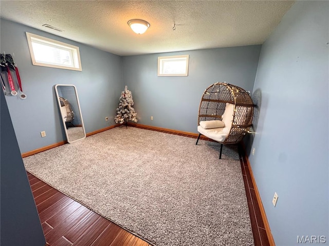 3581 Eagle Crest Dr, Palmyra, MO 63461 - unfurnished room with baseboards, a textured ceiling, healthy amount of natural light, wood finished floors, and carpet flooring