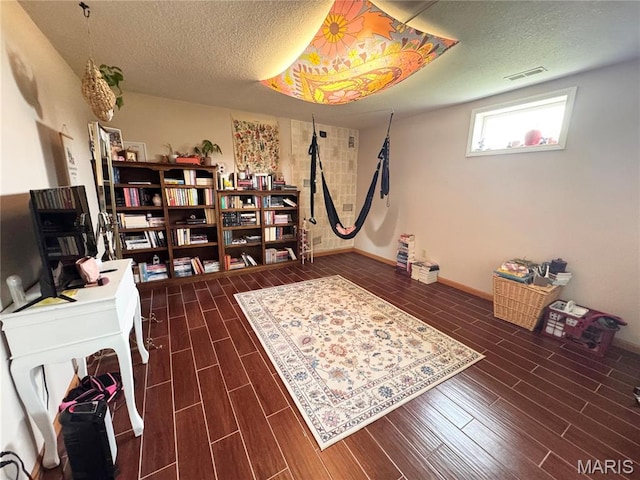 3581 Eagle Crest Dr, Palmyra, MO 63461 - office space featuring a textured ceiling, dark wood-type flooring, and baseboards