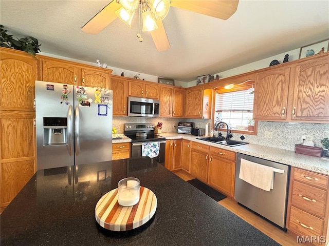 3581 Eagle Crest Dr, Palmyra, MO 63461 - kitchen featuring stainless steel appliances, a sink, decorative backsplash, and ceiling fan