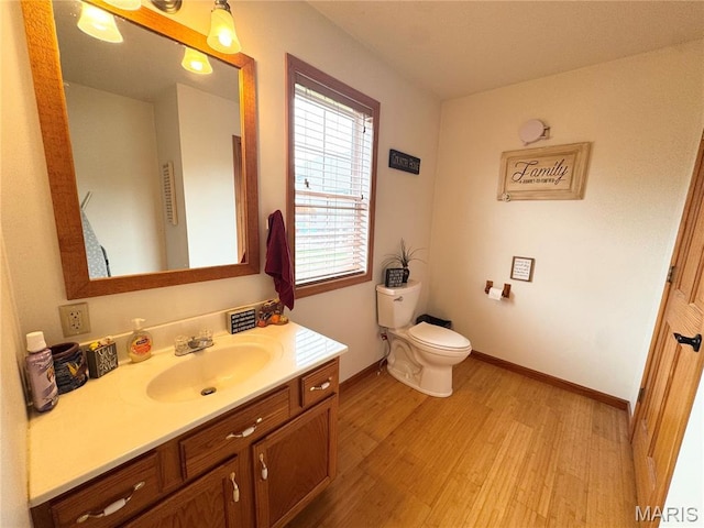 3581 Eagle Crest Dr, Palmyra, MO 63461 - bathroom featuring wood finished floors, vanity, toilet, and baseboards