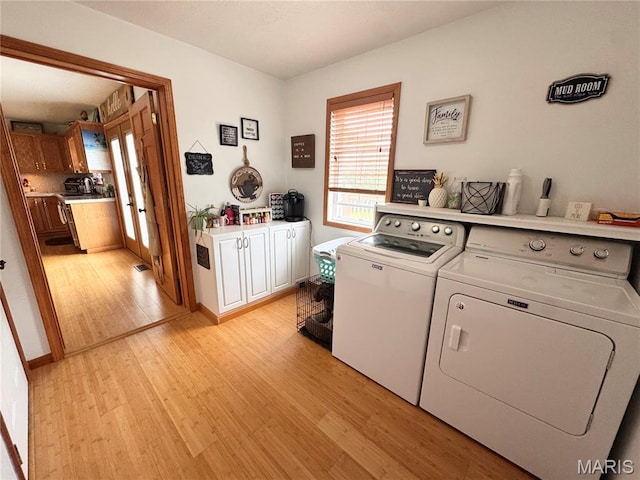 3581 Eagle Crest Dr, Palmyra, MO 63461 - laundry area with washing machine and clothes dryer, cabinet space, and light wood-style floors
