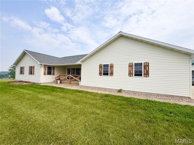 3581 Eagle Crest Dr, Palmyra, MO 63461 - back of house with a lawn and roof with shingles