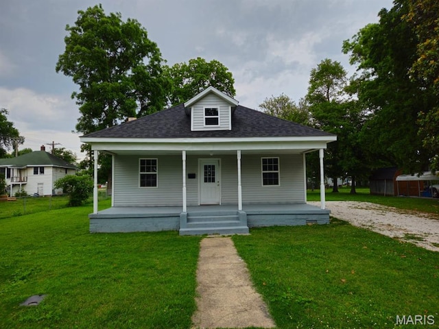 308 E Kathleen, Sikeston, MO 63801 - view of front of home with covered porch, a front yard, and roof with shingles