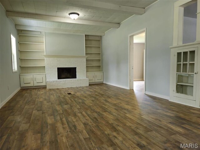 308 E Kathleen, Sikeston, MO 63801 - unfurnished living room with dark wood-style floors, baseboards, beam ceiling, and a fireplace