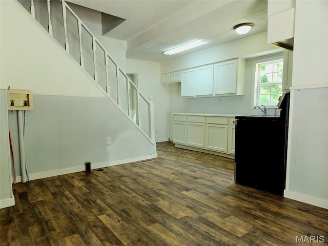 308 E Kathleen, Sikeston, MO 63801 - kitchen featuring dark wood-type flooring, light countertops, white cabinets, and a wainscoted wall