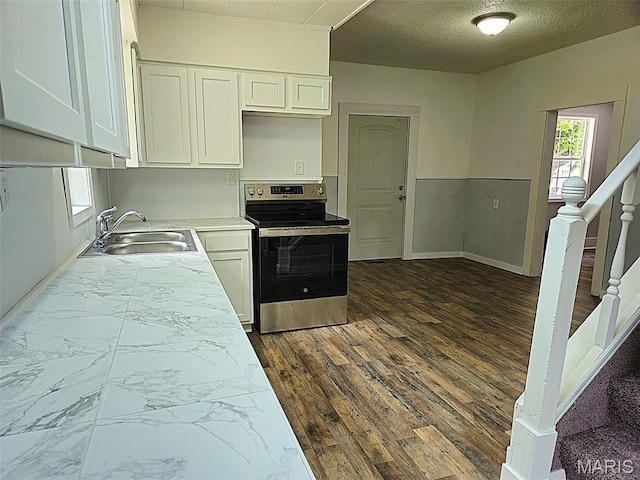 308 E Kathleen, Sikeston, MO 63801 - kitchen with stainless steel range with electric cooktop, a sink, white cabinetry, light countertops, and baseboards