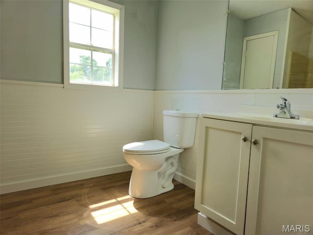 308 E Kathleen, Sikeston, MO 63801 - bathroom with toilet, vanity, wood finished floors, baseboards, and wainscoting