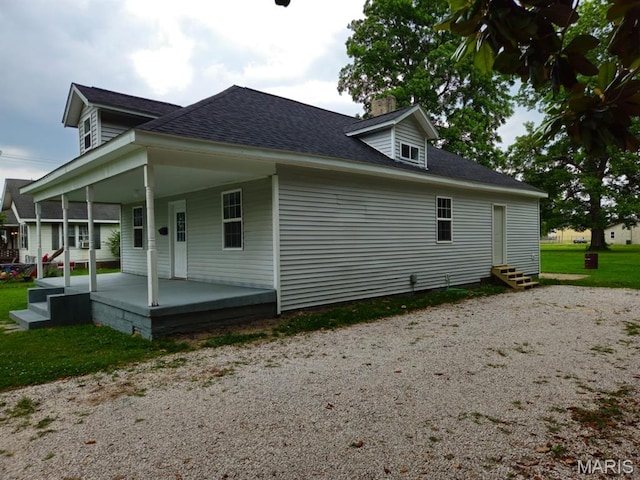 308 E Kathleen, Sikeston, MO 63801 - view of side of property with entry steps, a chimney, roof with shingles, and covered porch