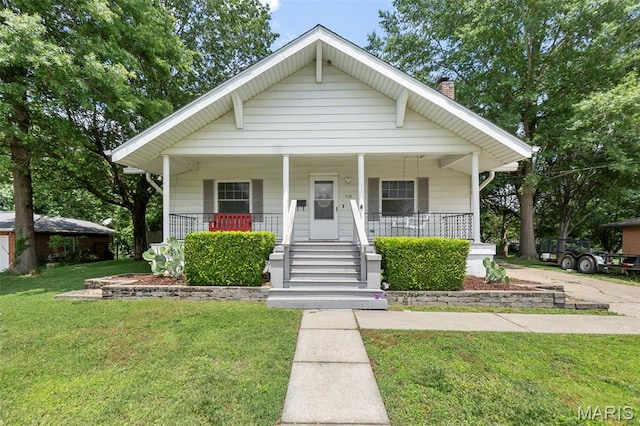 618 Parkview St, Jackson, MO 63755 - bungalow-style home featuring a porch, a chimney, and a front lawn