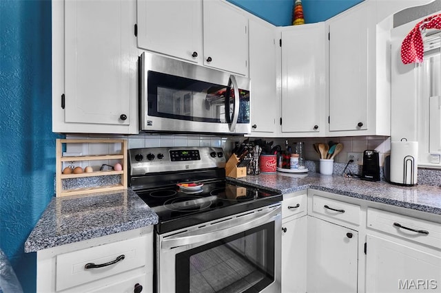 618 Parkview St, Jackson, MO 63755 - kitchen featuring stainless steel appliances, a textured wall, white cabinetry, and decorative backsplash