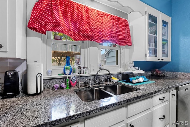 618 Parkview St, Jackson, MO 63755 - kitchen with a sink, stainless steel dishwasher, white cabinetry, glass insert cabinets, and dark stone counters