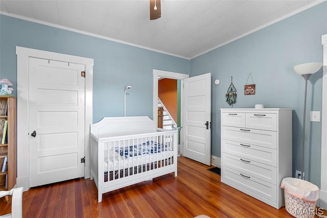 618 Parkview St, Jackson, MO 63755 - bedroom featuring a nursery area, wood-type flooring, crown molding, and a ceiling fan