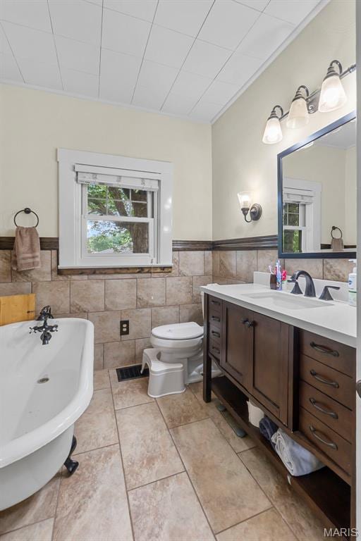 618 Parkview St, Jackson, MO 63755 - full bathroom with tile walls, a freestanding bath, vanity, wainscoting, and tile patterned floors