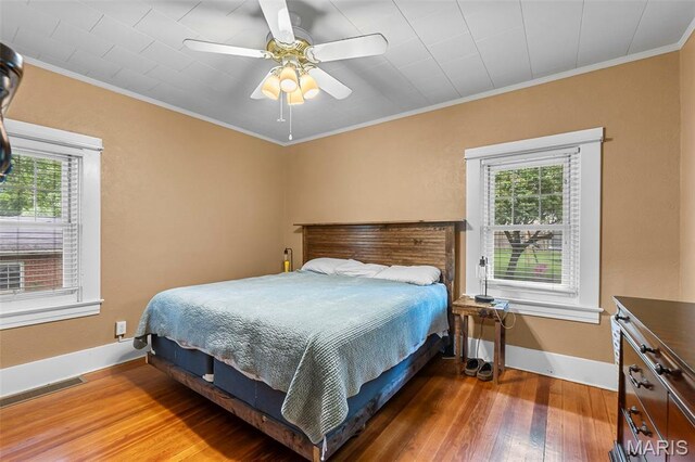 618 Parkview St, Jackson, MO 63755 - bedroom featuring wood finished floors, multiple windows, ornamental molding, baseboards, and ceiling fan