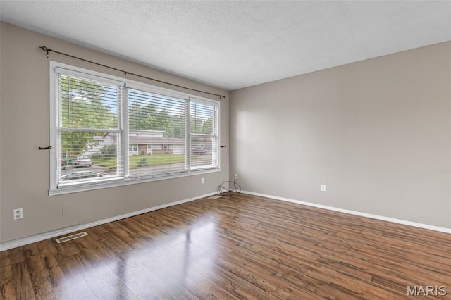 1 Mileva Ct, Farmington, MO 63640 - spare room featuring wood finished floors, baseboards, and a textured ceiling