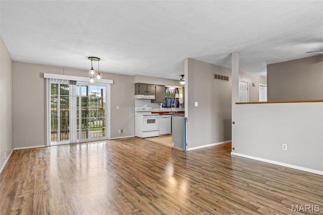 1 Mileva Ct, Farmington, MO 63640 - unfurnished living room featuring a ceiling fan, light wood-style flooring, baseboards, and a textured ceiling