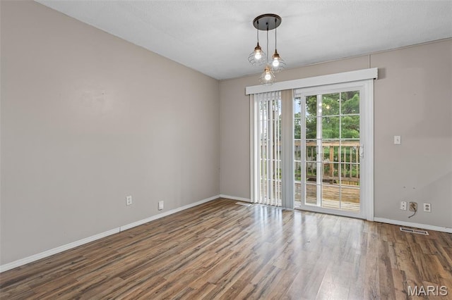1 Mileva Ct, Farmington, MO 63640 - empty room featuring baseboards, wood finished floors, and a textured ceiling