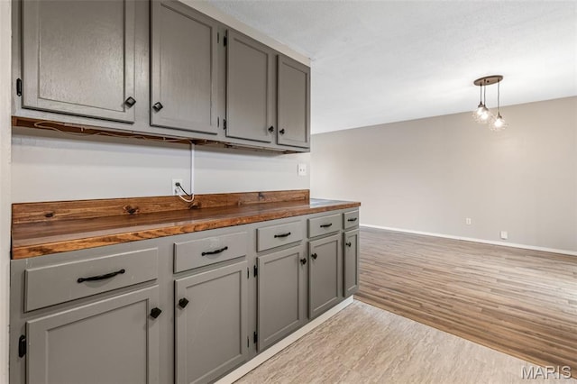 1 Mileva Ct, Farmington, MO 63640 - kitchen featuring gray cabinets, light wood-style flooring, baseboards, and pendant lighting